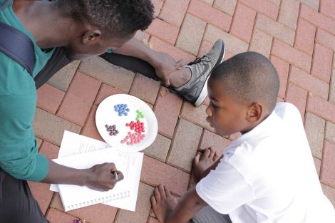 A Lafayette College student and Cheston Elementary School third-grader learn math by using Skittles during a Center for Community Engagement program.