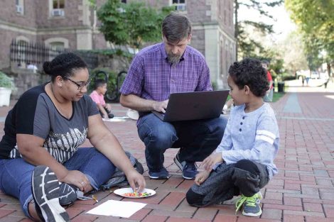 Professor Trent Gaugler watches as one of his Lafayette College students teaches a third-grader math using Skittles.