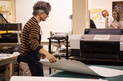 Pedro Barbeito, director of Lafayette College's Experimental Printmaking Institute, grabs paper
