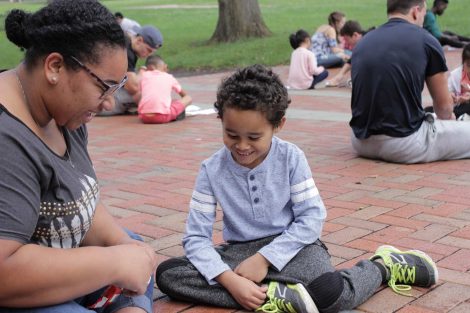 A Lafayette College student and Cheston Elementary School third-grader laught while learning math by using Skittles during a Center for Community Engagement program.