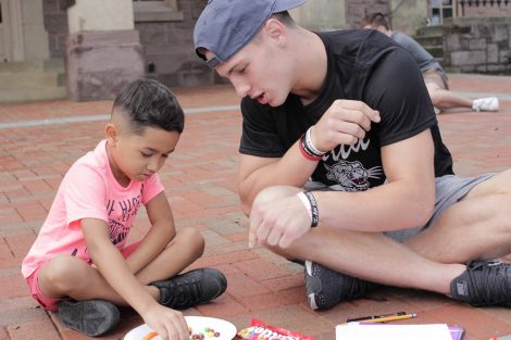 A Lafayette College student teaches a Cheston Elementary School third-grader math using Skittles.
