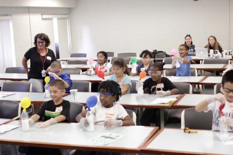 Students are shocked as balloons fill with carbon dioxide.
