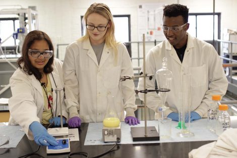 Students demonstrate how the magnet spins in the lab.