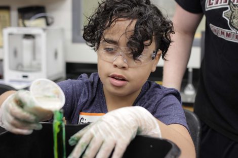 Student adds yeast to the beaker.