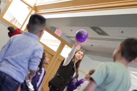 Lafayette student tosses in the first balloon to the group.