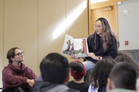 Lafayette student reads the book Stone Soup to a group of elementary students.