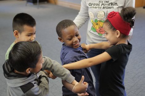 Elementary students work to untangle themselves.