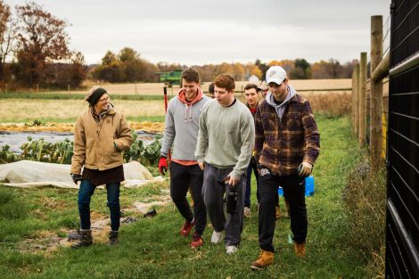 Lisa Miskelly, assistant director of food and farm, talks to members of Phi Psi fraternity helping with the building of a hoop house, a 22-by-21-foot structure that will help LaFarm extend its growing season earlier in spring and later in fall.