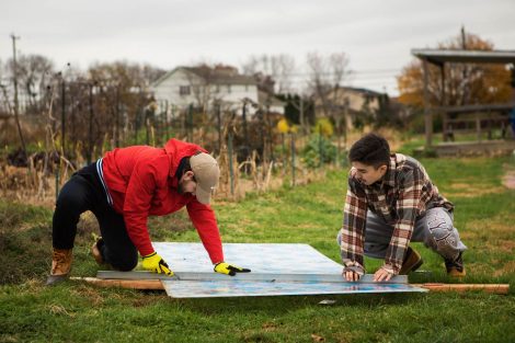 Members of Phi Psi fraternity help with the building of a hoop house, a 22-by-21-foot structure that will help LaFarm extend its growing season earlier in spring and later in fall.
