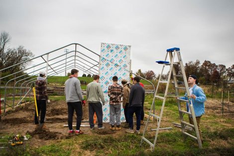 Members of Phi Psi fraternity help with the building of a hoop house, a 22-by-21-foot structure that will help LaFarm extend its growing season earlier in spring and later in fall.