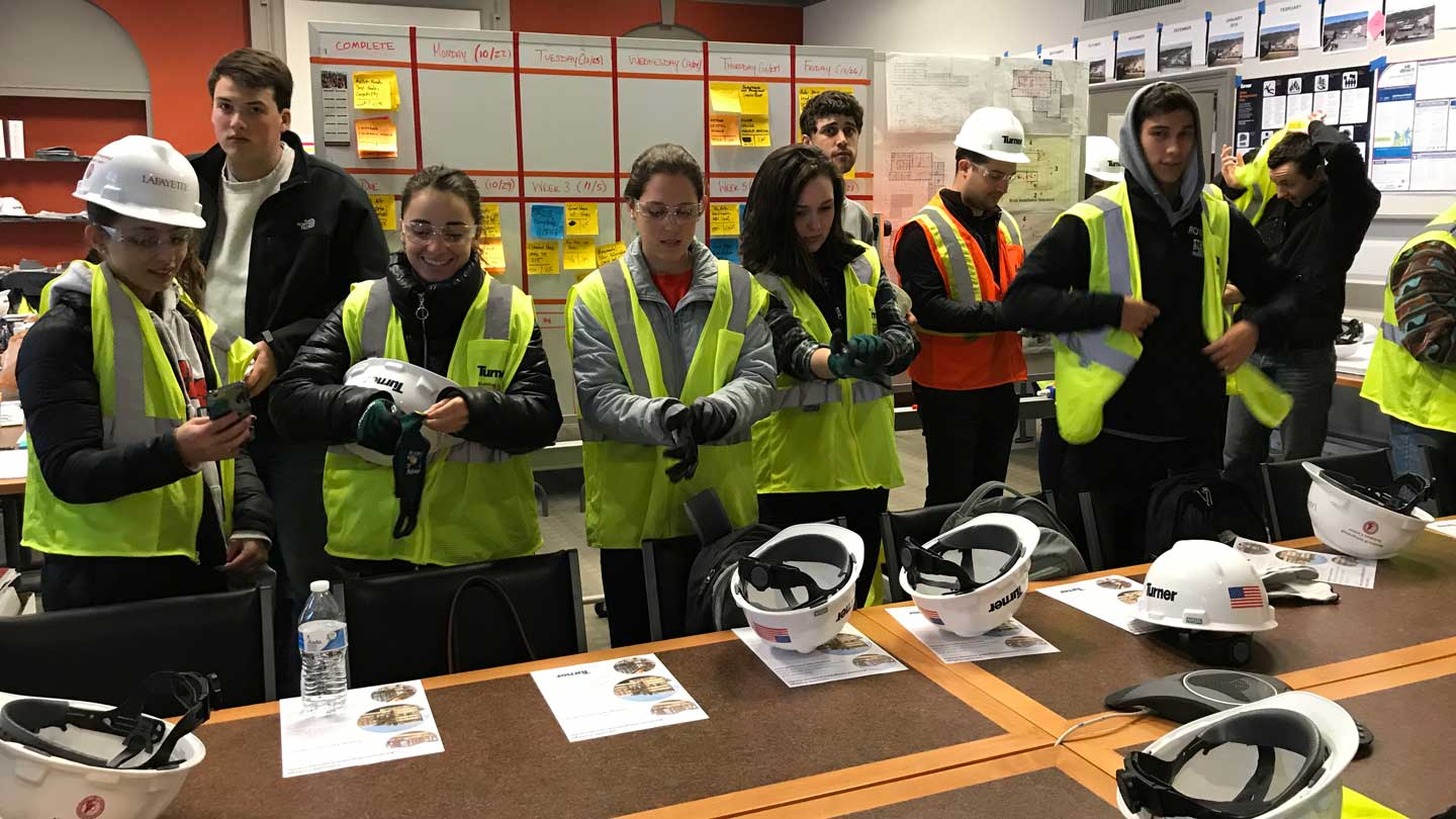 Students put on safety equipment for a tour of Rockwell Integrated Sciences Center.