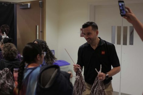 Wells Fargo employee hands out pom poms.