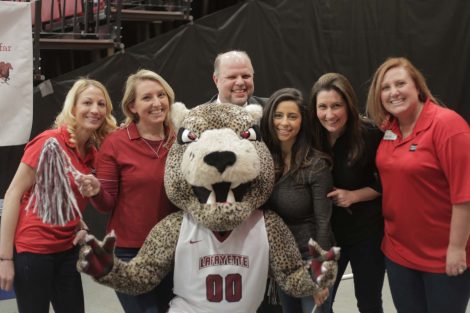 Wells Fargo team poses with the Leopard mascot.
