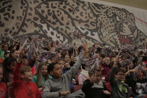 Fifth graders cheer for the team.