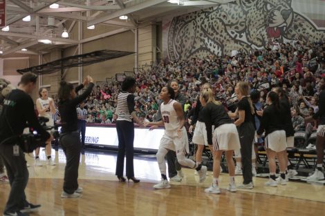 Starting line up has another player running on to the court.
