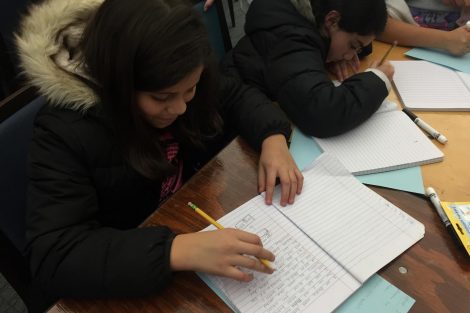 Cheston Elementary School children write in their notebooks.