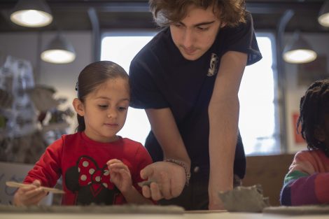 A Lafayette students works with a young kindergatner.