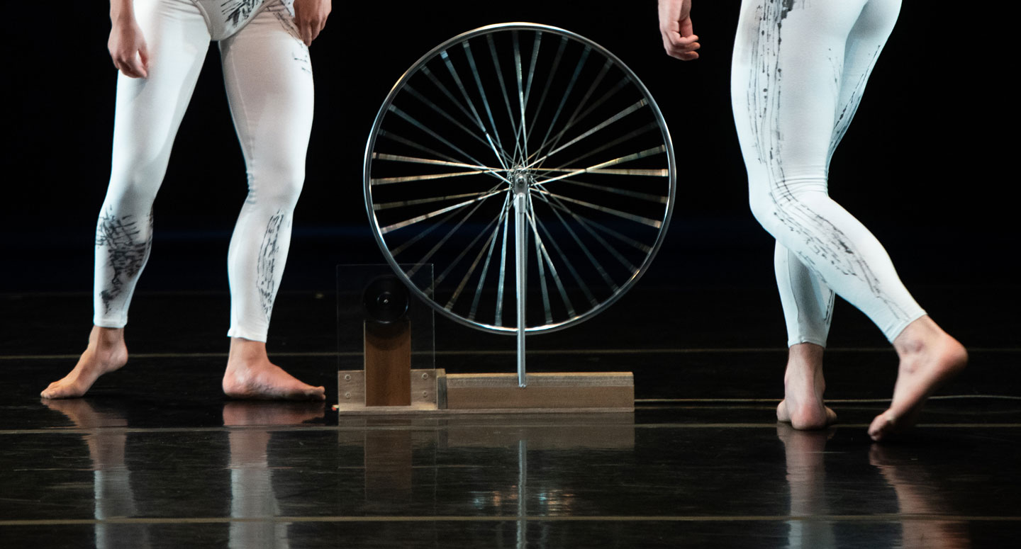A view of a wheel and the legs for two Taylor 2 Dance dancers performing on stage at Lafayette College's Williams Center for the Arts