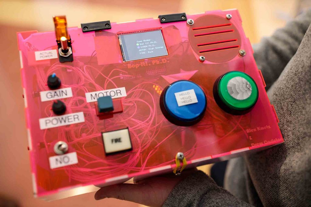 The face of a control panel that operates the Dr. Bop-It toy.