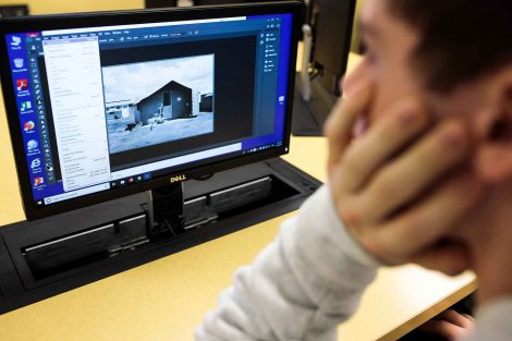 Student works in Photoshop on an image.