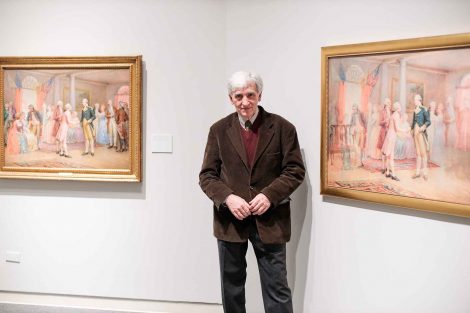 Cedomir Vasic stands in front of two images--one of George Washington meeting Lafayette and his image where the men disappear.