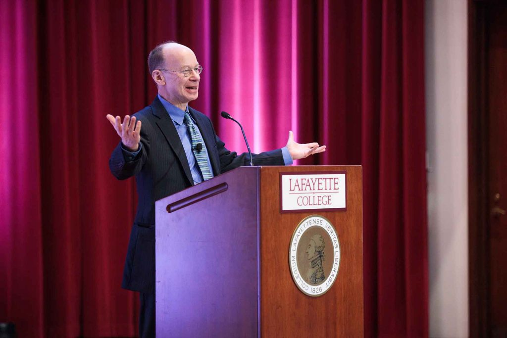 Alan Cooperman answers a question at the podium.