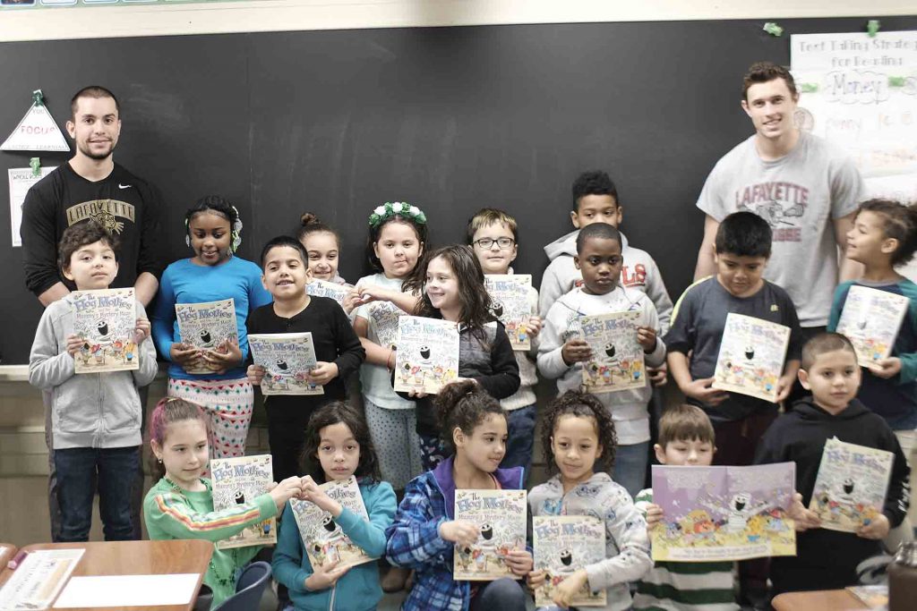 A group shot of the lacrosse players and the entire second grade class.