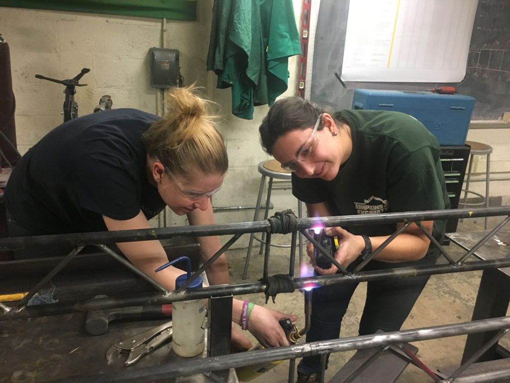 Rebecca Cook ’20 and Kari Schultheis ’19 work on the steel bridge.