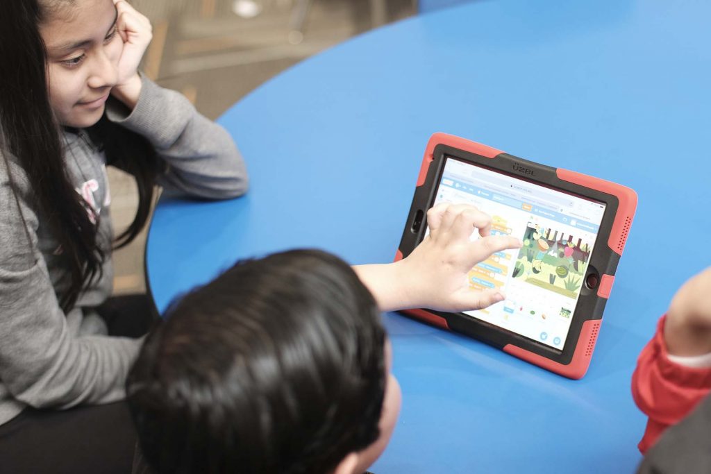 Third grader plays a game he created where a duck moves in a fruit jungle.