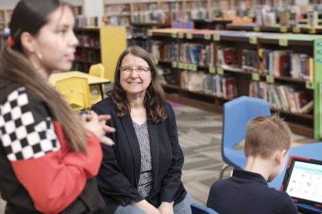 Computer Science Professor Joann Ordille listens as students talk code.