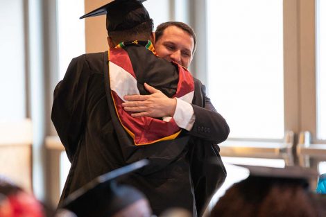 D.C. 8 faculty mentor Josh Smith gets a hug from one of his scholars
