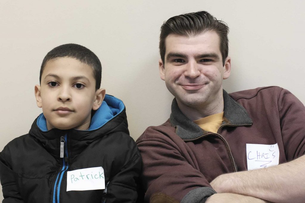 Patrick sits next to his pen pal Chris