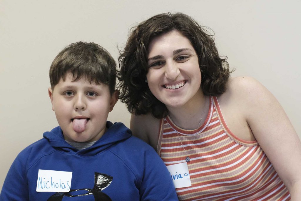 Nicholas sits next to his pen pal Olivia