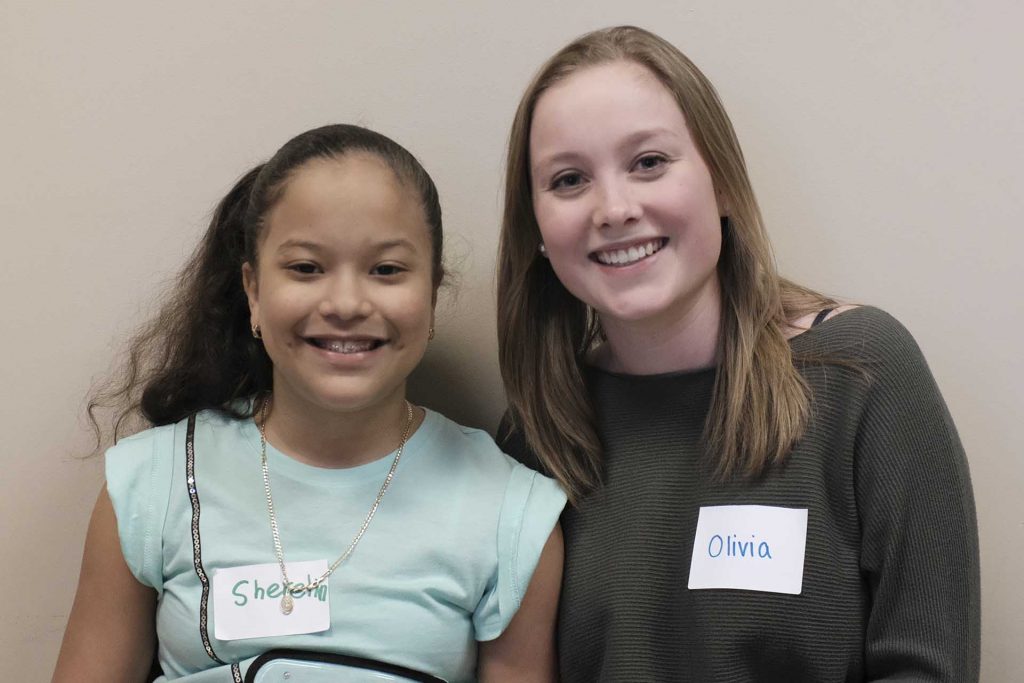 Sherelin sits next to her pen pal Olivia