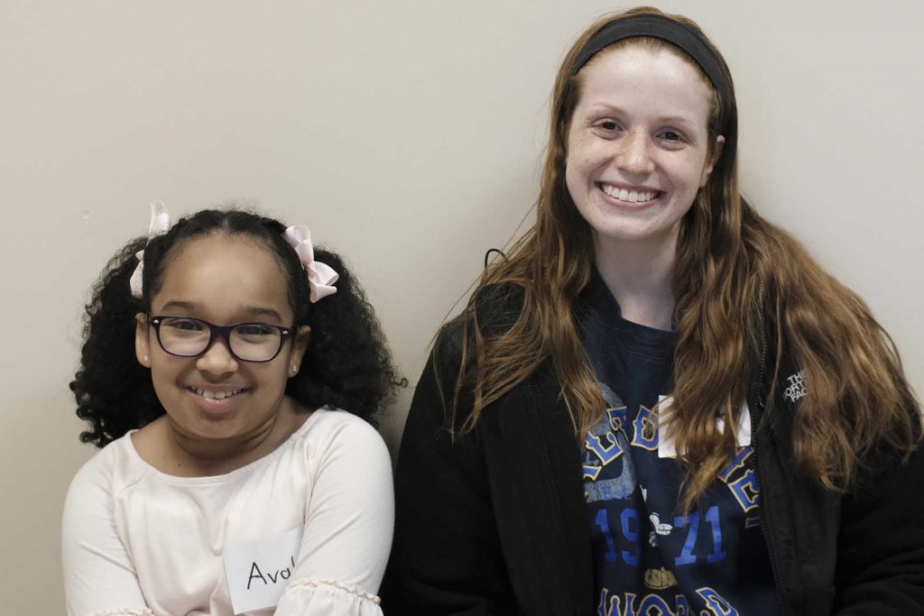 Sarah sits next to her pen pal Avalon
