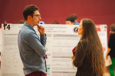 Students explain their research to visitors at the 2019 spring poster session in Kamine Gymnasium in Kirby Sports Center.