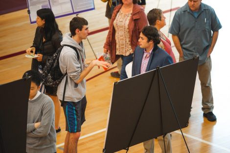 Students explain their research to visitors at the 2019 spring poster session in Kamine Gymnasium in Kirby Sports Center.