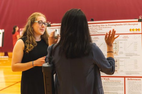 Students explain their research to visitors at the 2019 spring poster session in Kamine Gymnasium in Kirby Sports Center.