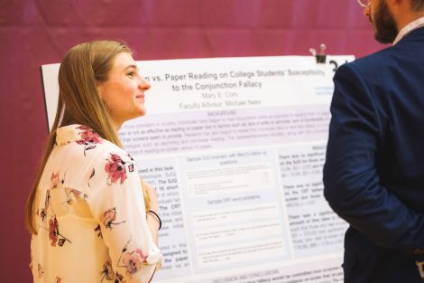 Students explain their research to visitors at the 2019 spring poster session in Kamine Gymnasium in Kirby Sports Center.