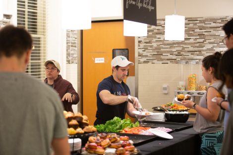 Students chow down on breakfast food late at night, served up by faculty and staff.