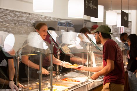 Students chow down on breakfast food late at night, served up by faculty and staff.