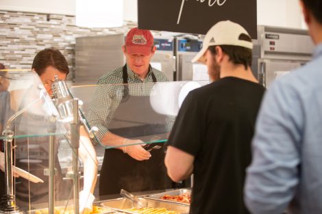 Students chow down on breakfast food late at night, served up by faculty and staff.