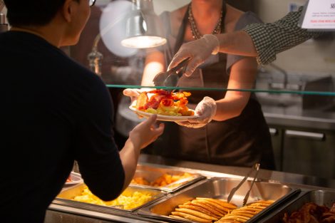 Students chow down on breakfast food late at night, served up by faculty and staff.