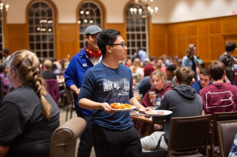 Students chow down on breakfast food late at night, served up by faculty and staff.