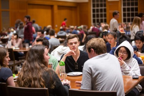 Students chow down on breakfast food late at night, served up by faculty and staff.