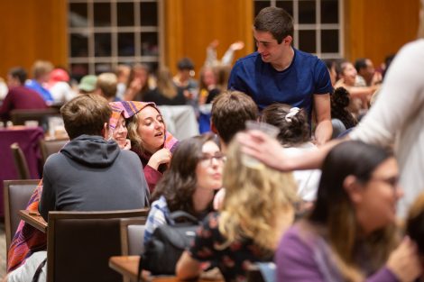 Students chow down on breakfast food late at night, served up by faculty and staff.