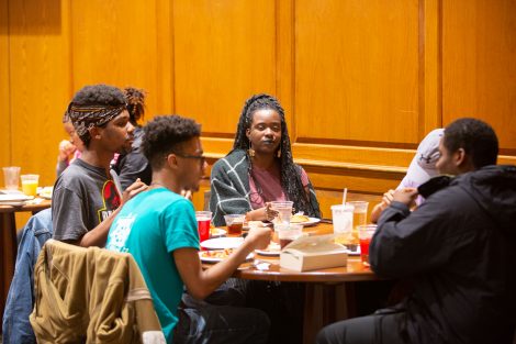 Students chow down on breakfast food late at night, served up by faculty and staff.