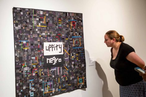 A guest looks at a quilt made by Chawne Kimber
