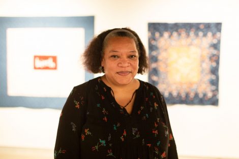 Chawne Kimber, professor of mathematics, and two of her quilts