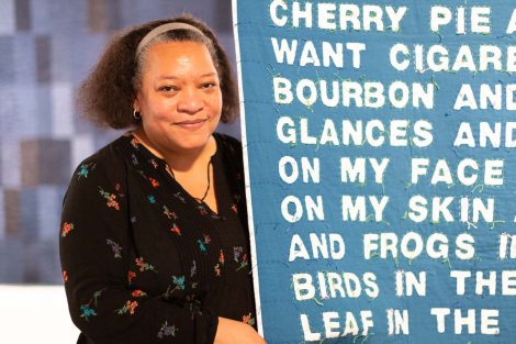 Chawne Kimber poses with one of her quilts